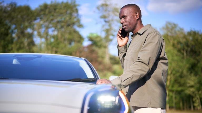 ford servicing eu feature 16x9 2160x1215 Modules man standing next to car on road side with warning triangle